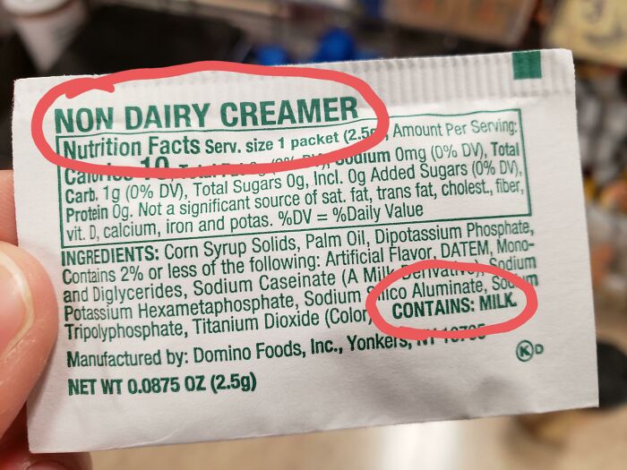 A non-dairy creamer packet with 'Non-Dairy Creamer' and 'Contains: Milk' circled, demonstrating infuriating marketing practices.