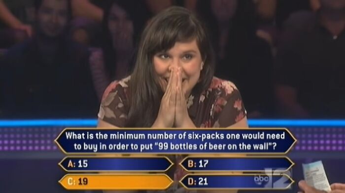 A Who Wants To Be A Millionaire contestant reacts with glee to a question, possibly a dumb answer.