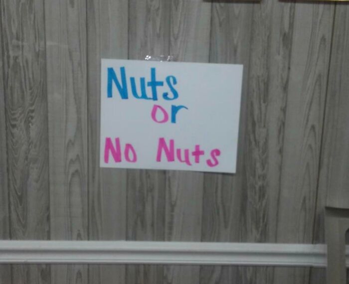 A sign asking 'Nuts or No Nuts' for gender reveal moments, showing anticipation for the baby's gender.