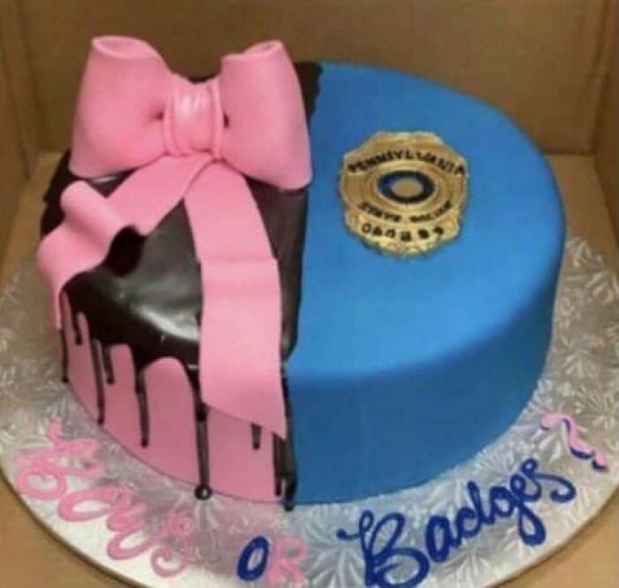 A gender reveal cake split into halves, one pink with a bow, the other blue with a police badge.