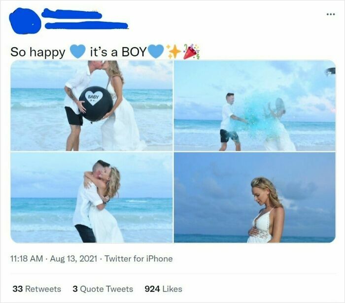 A couple celebrating a gender reveal on the beach, surrounded by blue powder, signifying the baby is a boy.