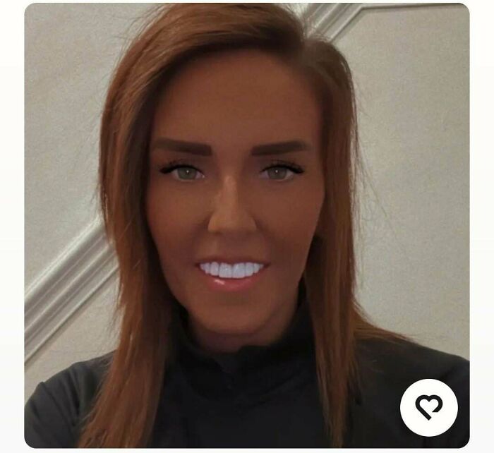 A woman with heavily bronzed skin, bright eyes, and white teeth, not looking natural on social media.