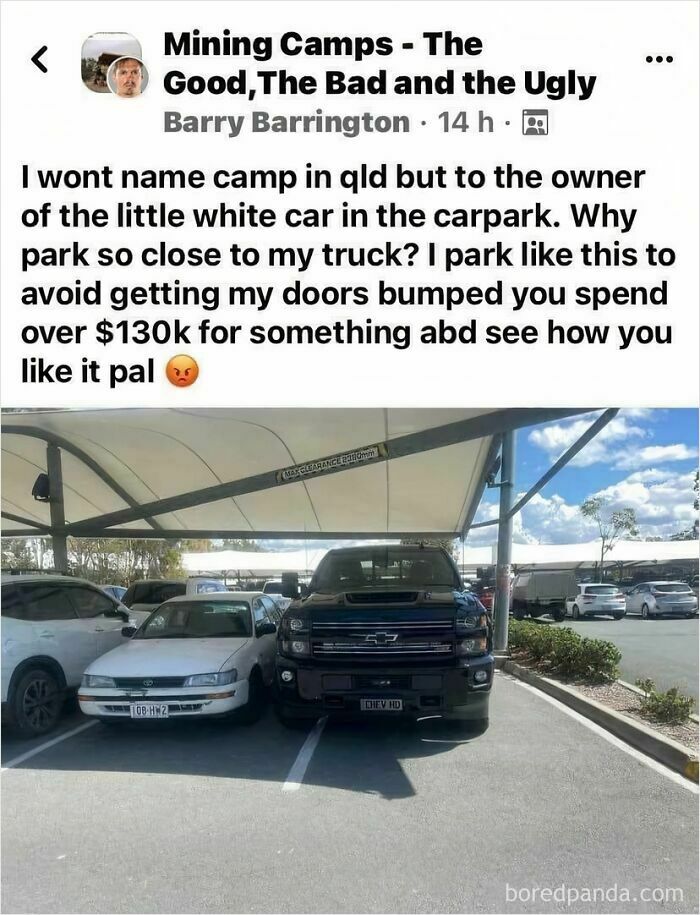 A black truck parked extremely close to a white car, highlighting people who think they're the main character.