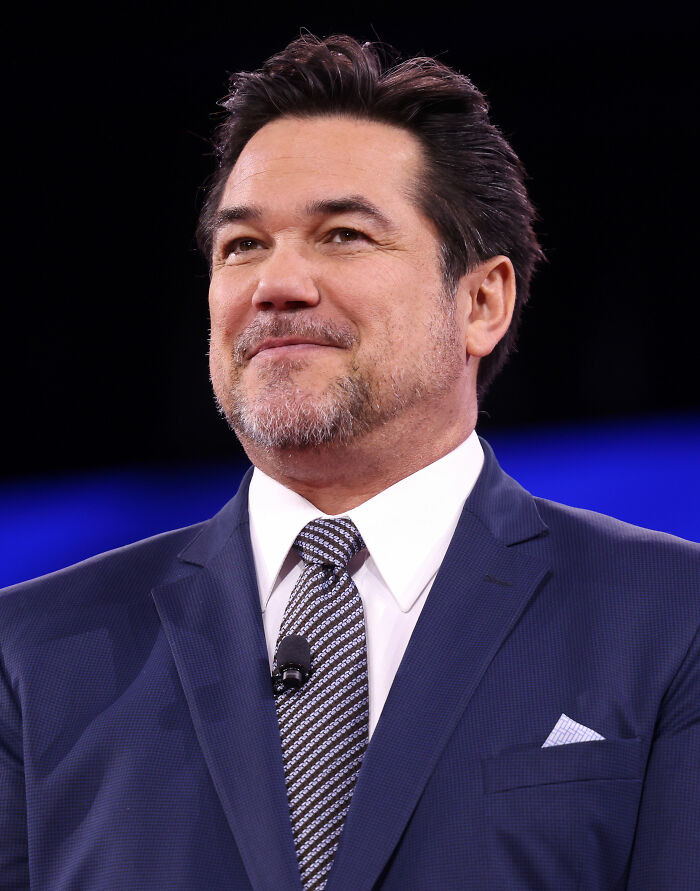 Dean Cain, best known for his acting career, smiling confidently in a suit during a public appearance.