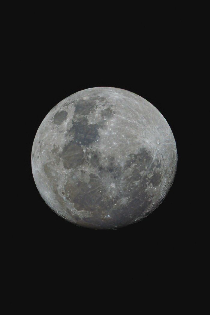 A detailed view of the full moon against a dark sky, an interesting post for Aussies.
