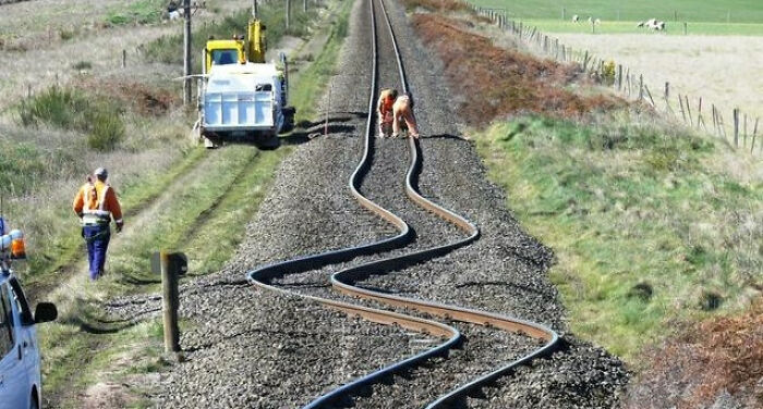 A railway track warped by heat in a real photo that makes your brain question if it was edited.
