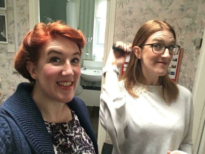 Two women, one smiling with red hair, the other with glasses, a real photo that makes your brain question if it was edited.