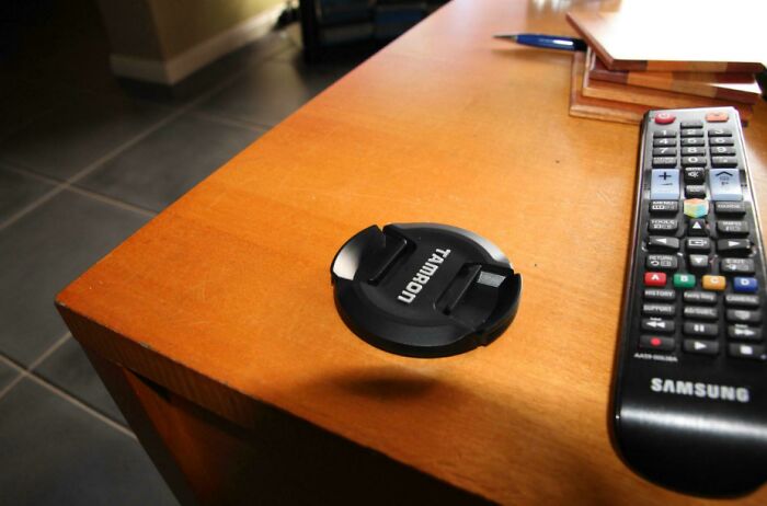 Real photos featuring a lens cap appearing to float above a table, making the brain question if they were edited.