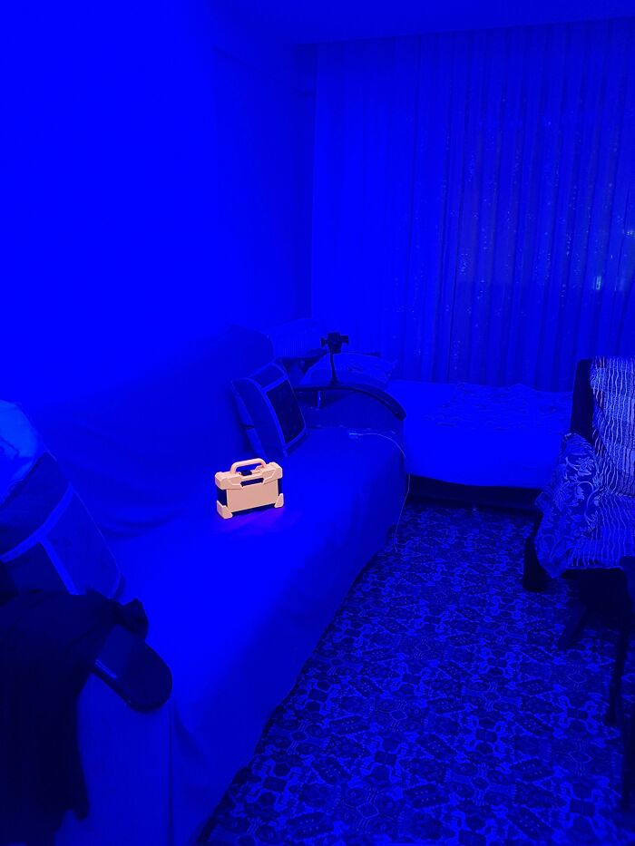 A room bathed in blue light with a yellow box, a real photo that makes you question if it was edited.
