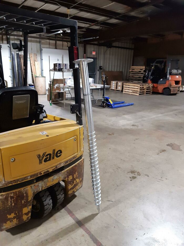 Real photos of a giant s***w next to a yellow forklift in a warehouse, making you question if it was edited.