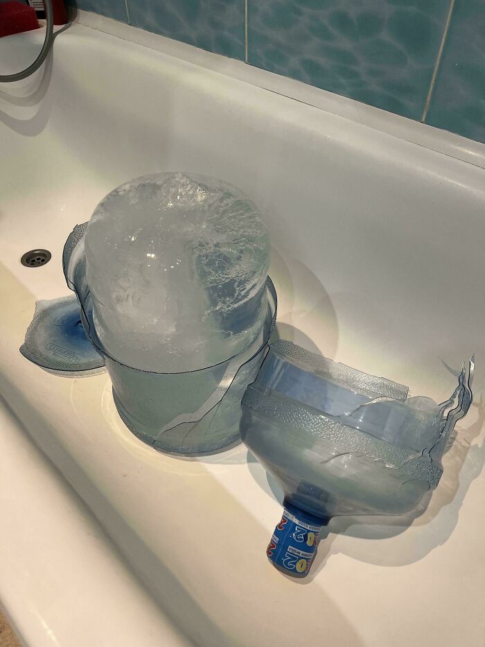 A large block of ice in a broken water cooler jug, demonstrating forgetting something important.