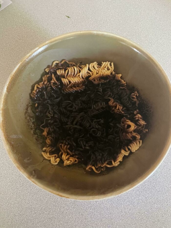 A bowl of instant noodles completely burnt, showing a moment someone ruined their day by forgetting to watch their food.