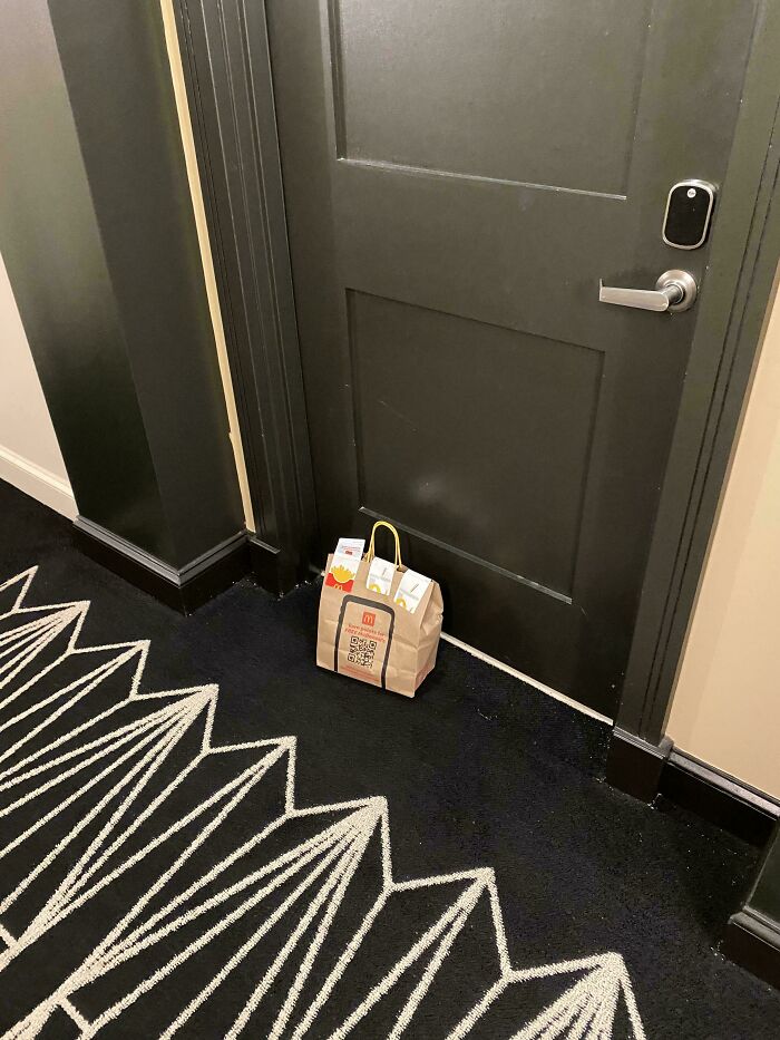 A McDonald's delivery bag left outside a door, signifying a ruined day by forgetting the delivery.