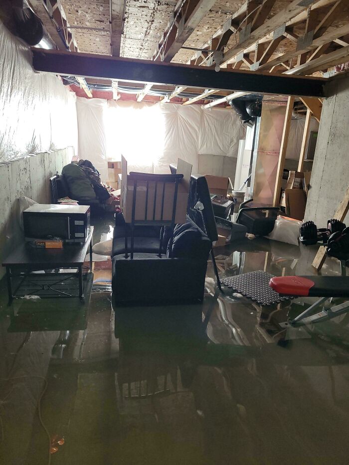 A flooded basement with furniture and boxes, showing how people ruin their day by forgetting something important.