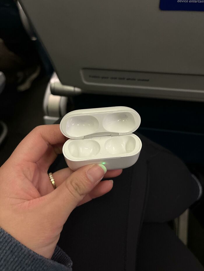An empty AirPods case held open, highlighting the feeling of forgetting something extremely important.