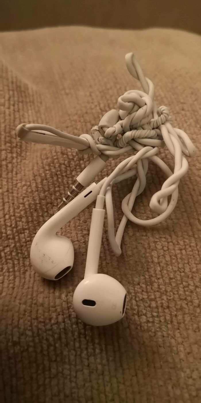 Tangled white earbuds, a common sight for forgetting organization, ruining a day.