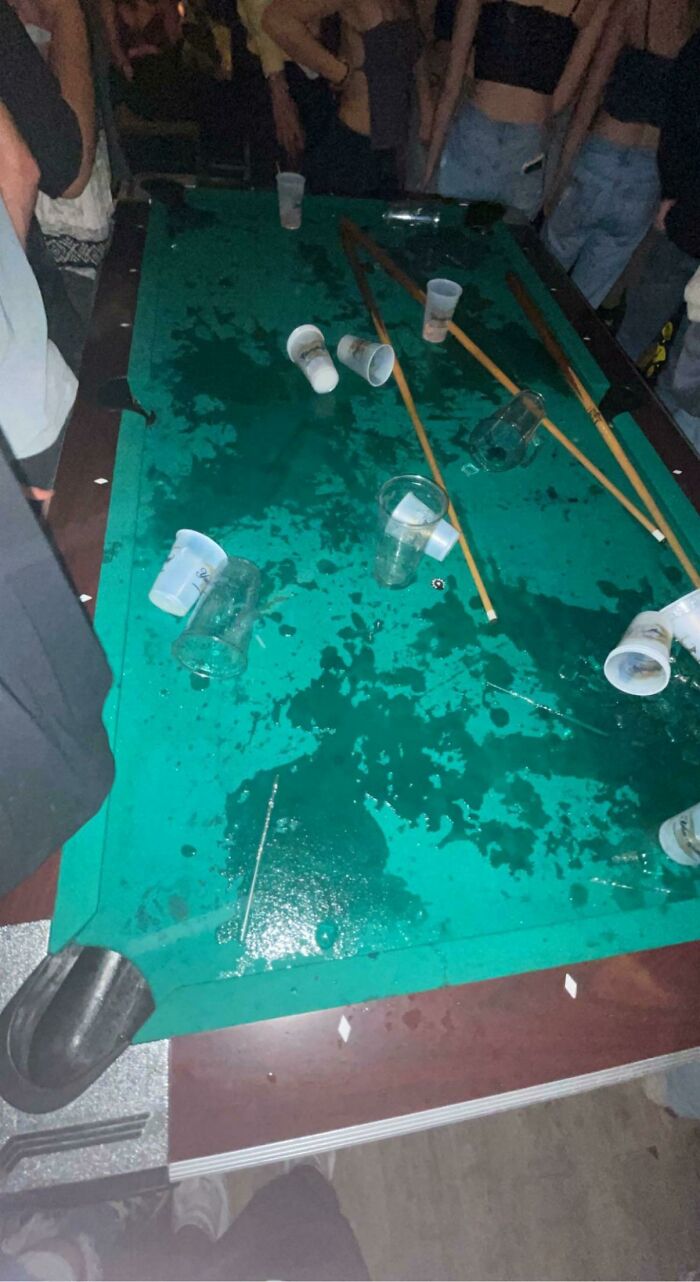 A spilled pool table with drinks and cues, a clear sign of a day ruined by forgetting.