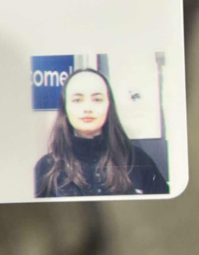 A woman with a prominent forehead on an ID card, a moment of forgetting something important causing a bad photo.