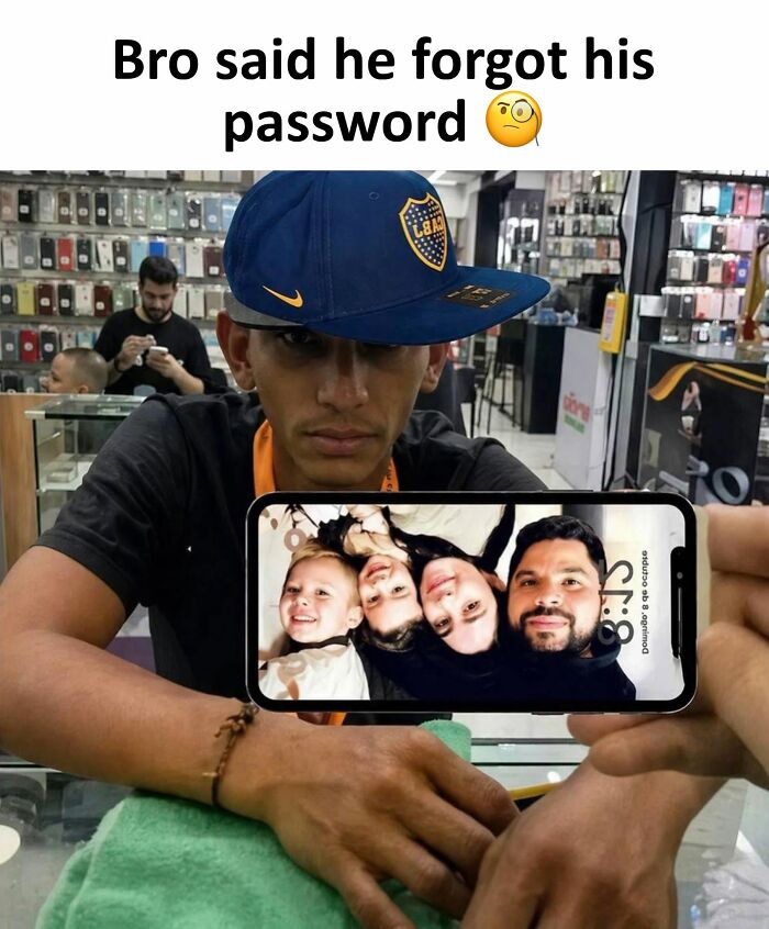 A man in a store holding a phone displaying a family photo, forgetting his password in hilarious posts from Xavier.