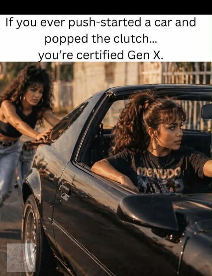 Two women pushing a car to push-start it, a Gen X meme about being certified.