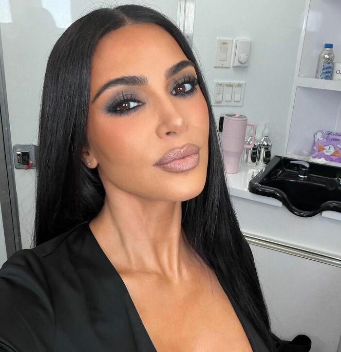 Kim Kardashian close-up selfie with smoky eye makeup and long black hair