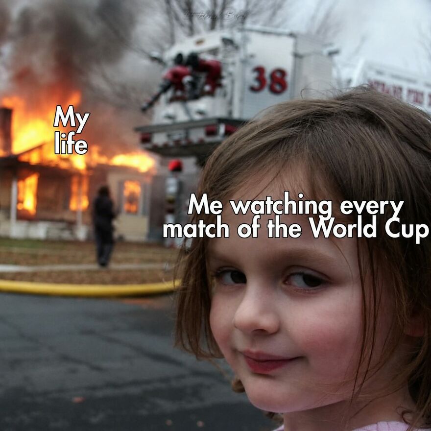 A girl smiling while a house burns in the background, a World Cup meme.