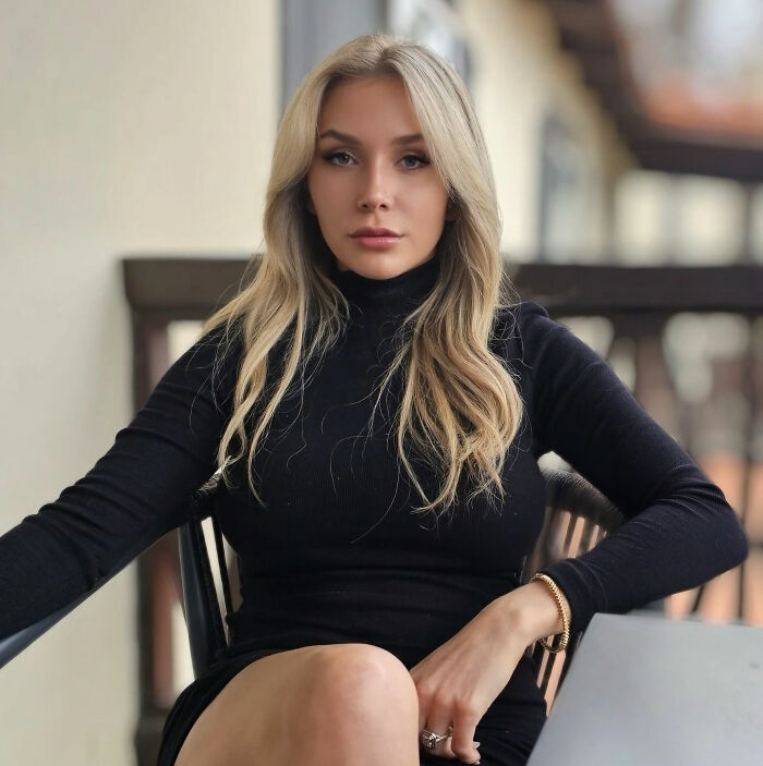 Courtney Stodden, a young blonde woman in a black dress, sitting and looking directly at the camera. Inappropriate comedy sketch. Courtney Stodden, a young blonde woman in a black dress, sitting and looking directly at the camera. Inappropriate comedy sketch.