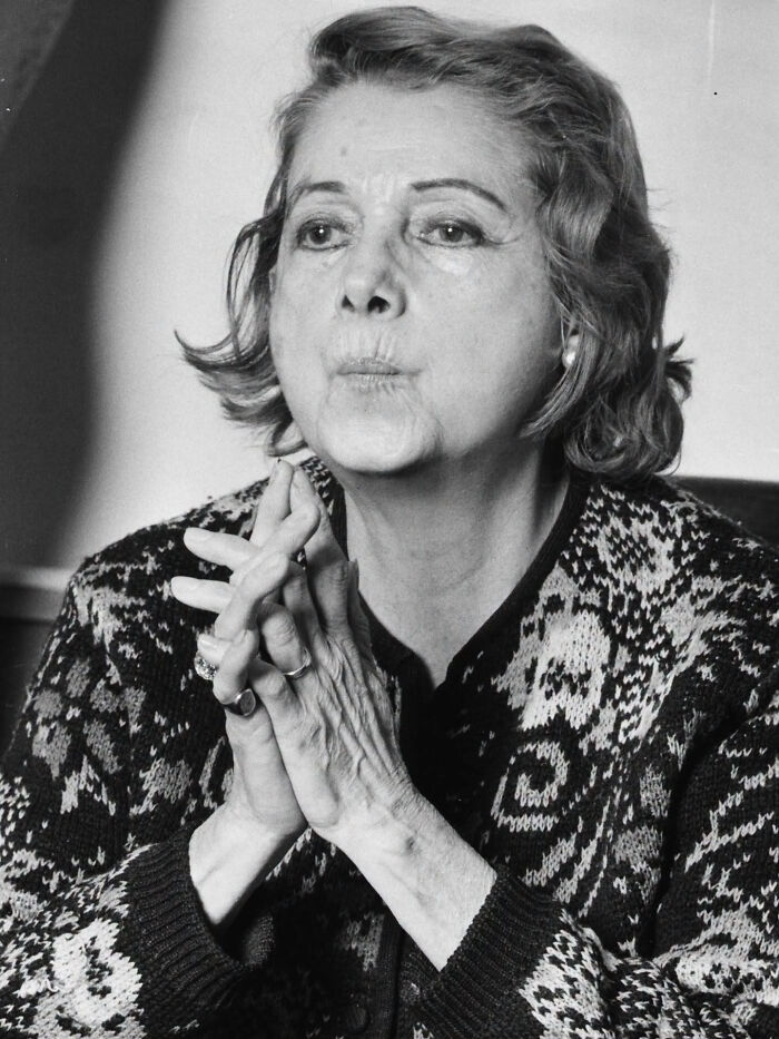 Close-up of a thoughtful woman with her hands clasped, illustrating overlooked women in history.