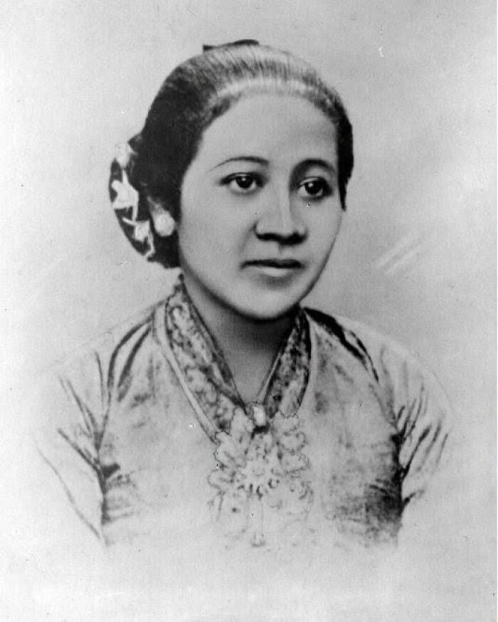 A black and white portrait of an overlooked woman in history, wearing traditional attire with her hair styled up, looking directly at the camera with a gentle expression.