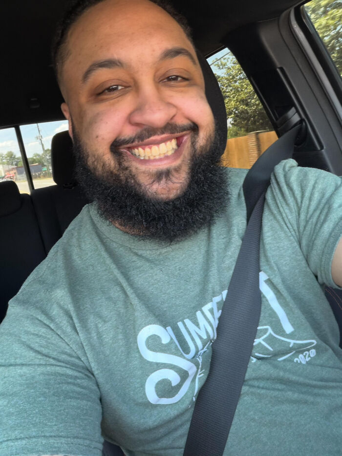 A man with a beard smiling, depicting surprising facts that don't match people's looks.