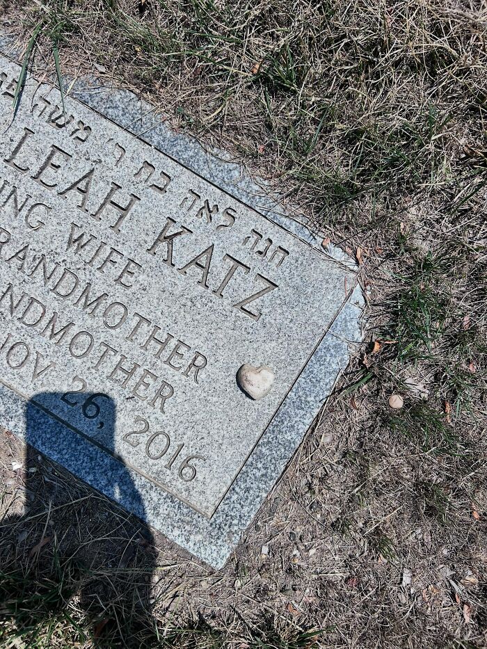 A small heart-shaped rock placed on a gravestone, a rare and touching thing that has happened to them.