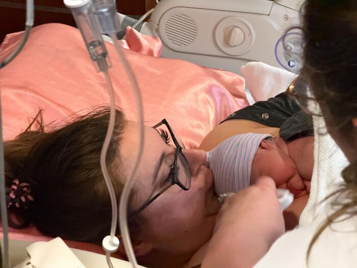 A mother and her newborn baby in a hospital bed, a rare and beautiful moment.