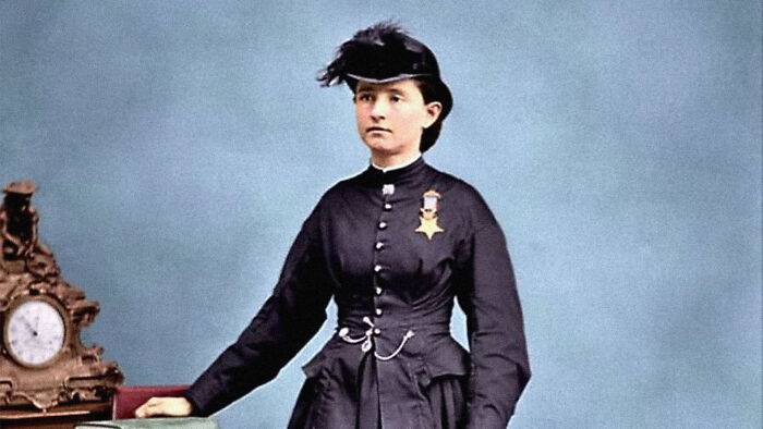 Dr. Mary Edwards Walker, a woman in history often overlooked, wearing a dark dress and hat, with a medal on her chest.