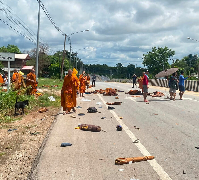 Scene of the incident with injured Buddhist monks and debris on the road after being hit by a pickup truck. Scene of the incident with injured Buddhist monks and debris on the road after being hit by a pickup truck.