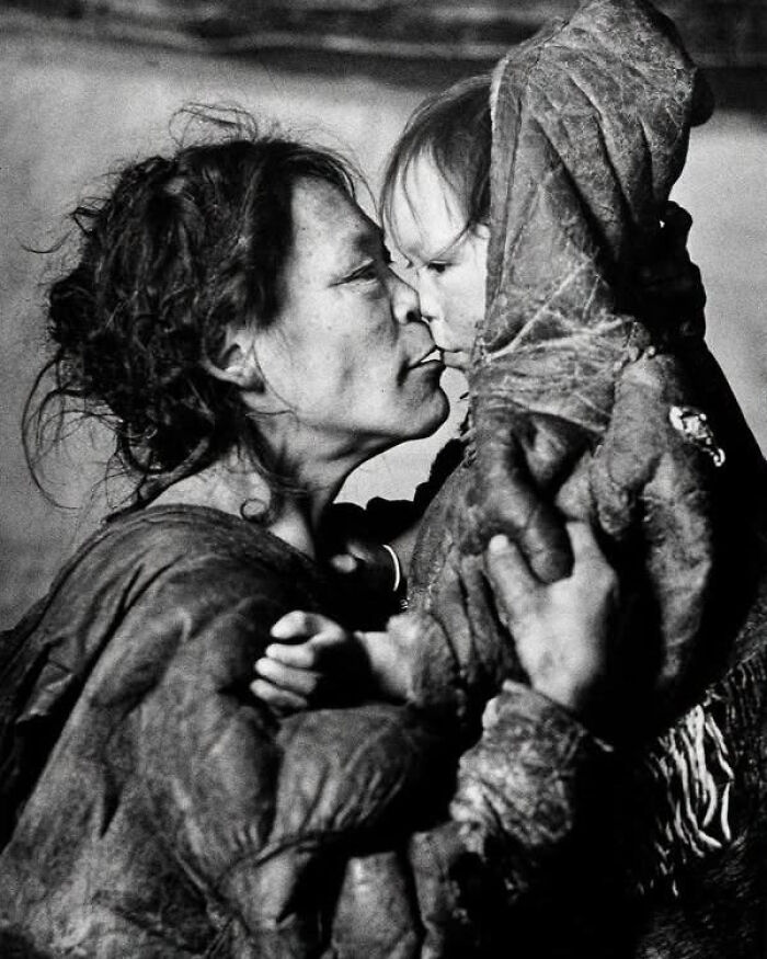 An older woman nose-kissing a child, depicting a powerful image of overlooked women in history.