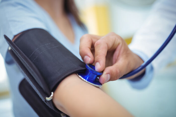 Doctor checking a patient's blood pressure, a common practice in the medical industry.