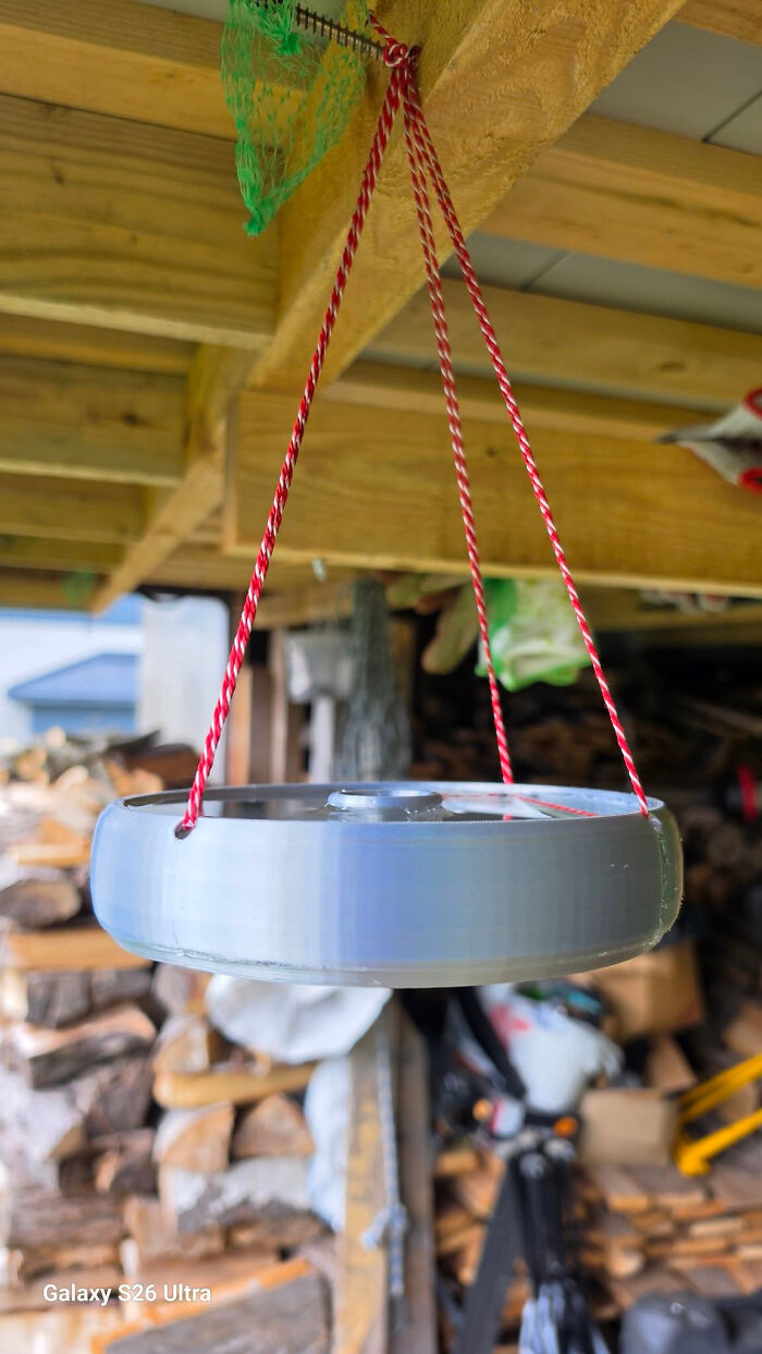 A hanging 3D printed bird feeder made from a recycled bottle, a cool and useful creation.