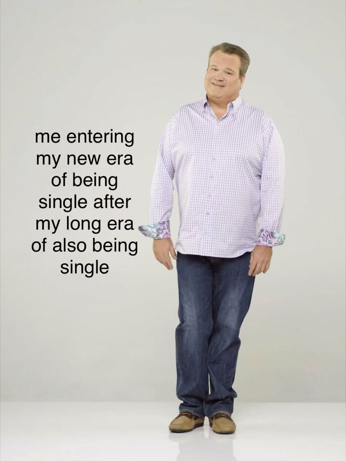 A full-body shot of Jesse Tyler Ferguson as Cameron Tucker, with text about relatable memes: 'me entering my new era of being single after my long era of also being single'.