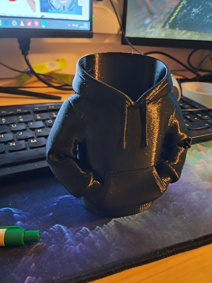 A black 3D printed hoodie-shaped container, cool and useful things created with a 3D printer.