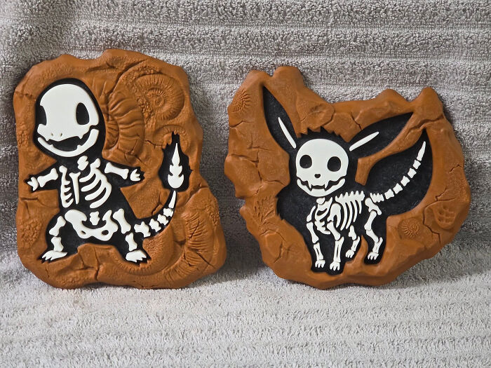 Two Pokemon fossil replicas, Charmander and Eevee, showcasing cool and useful things created with a 3D printer.