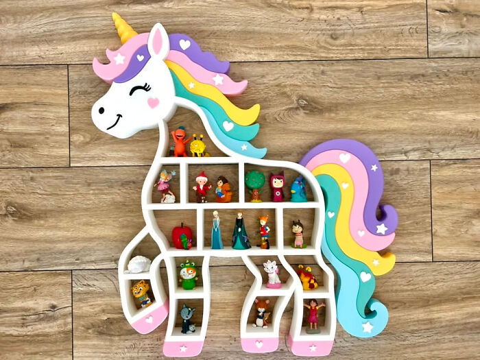 A colorful unicorn-shaped shelf, 3D printed to display small toys and figurines.