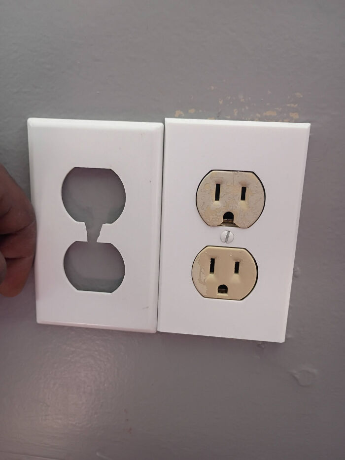 A white 3D printed wall plate next to an electrical outlet, ready for installation.