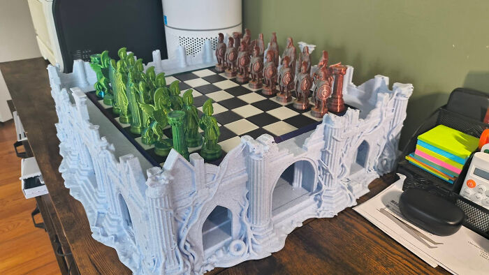 An elaborate 3D printed chess set with a castle-like board, a useful thing created with a 3D printer.