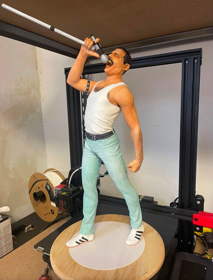 A large, realistic 3D printer figure of Freddie Mercury singing into a microphone, a cool creation.