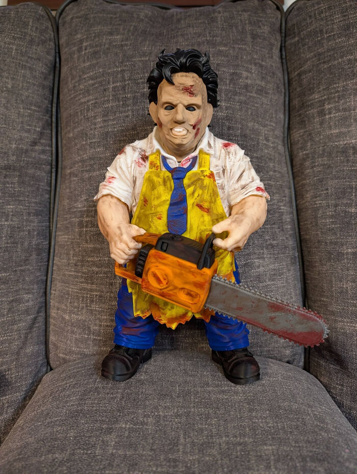 A Leatherface figurine holding a chainsaw, a cool and useful thing created with a 3D printer.