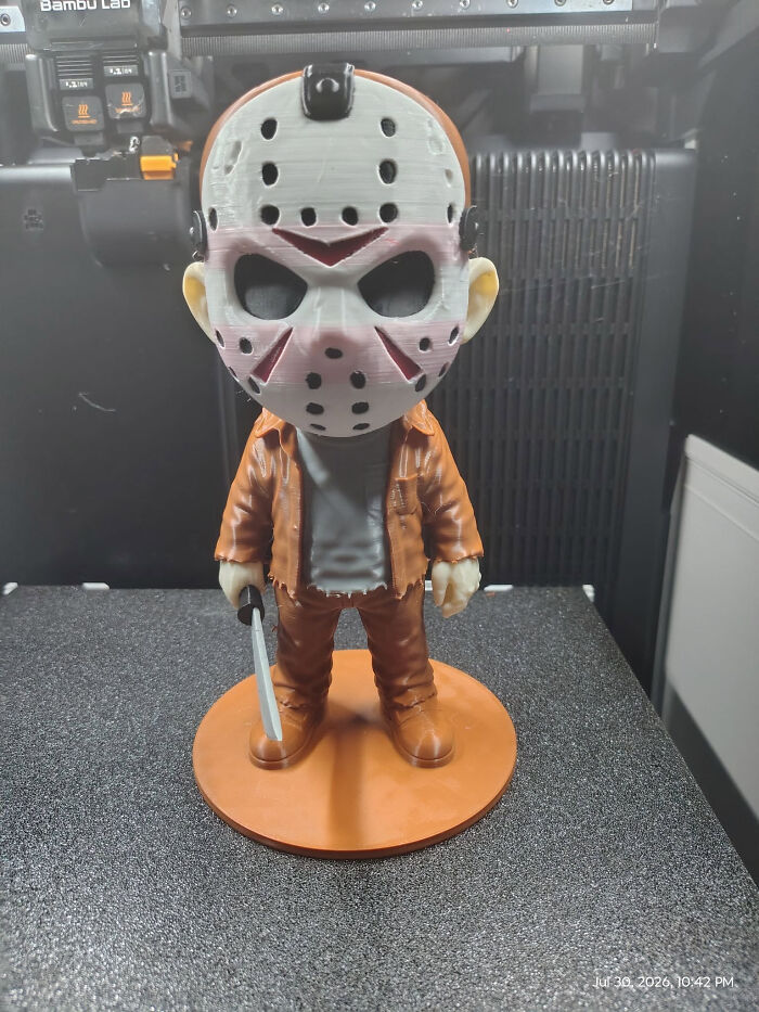 A cute 3D printer creation of a chibi Jason Voorhees figure with a mask and a knife.