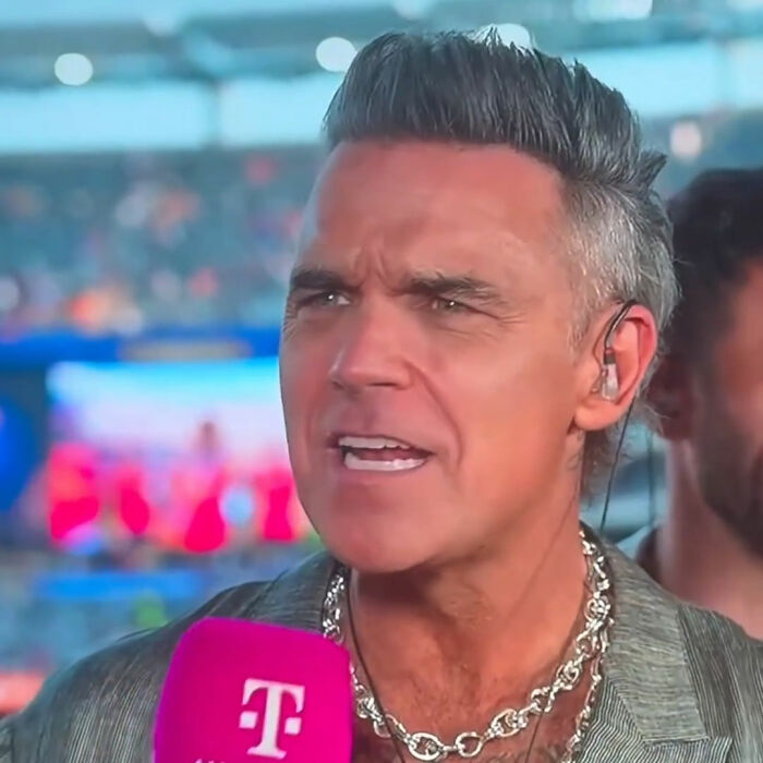 Robbie Williams breaks silence, looking concerned, during the World Cup moment where white substance fell on his mic. Robbie Williams breaks silence, looking concerned, during the World Cup moment where white substance fell on his mic.