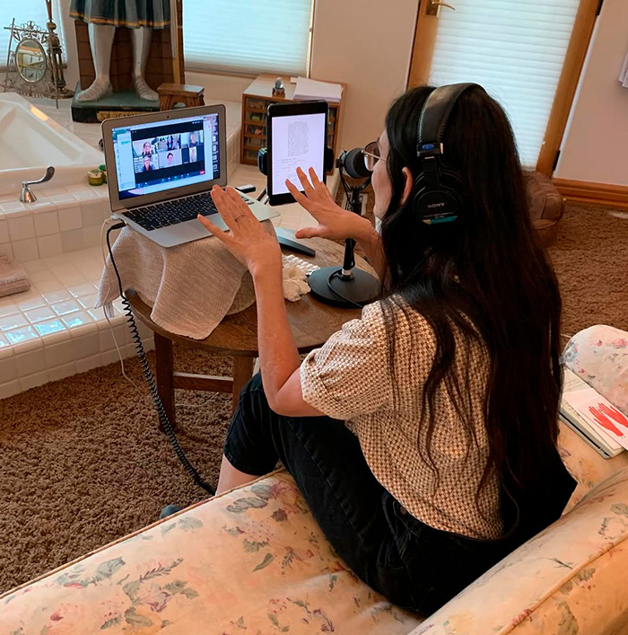 Demi Moore from behind, wearing headphones and gesturing while on a video call, highlighting questionable renovations. Demi Moore from behind, wearing headphones and gesturing while on a video call, highlighting questionable renovations.