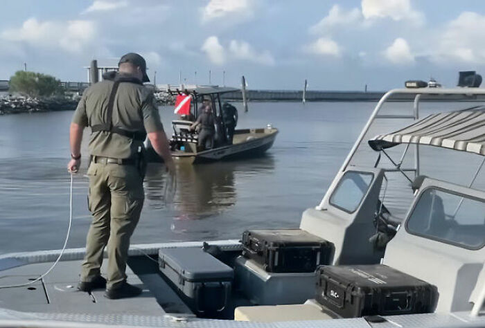 Two boats with uniformed personnel on water, related to the Nolan Wells scandalous case. Two boats with uniformed personnel on water, related to the Nolan Wells scandalous case.