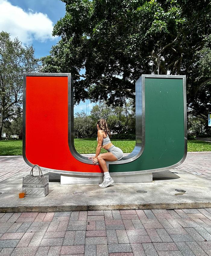 Adult star sitting on a large U-shaped sculpture outdoors, highlighting her career's unexpected reaction. Adult star sitting on a large U-shaped sculpture outdoors, highlighting her career's unexpected reaction.